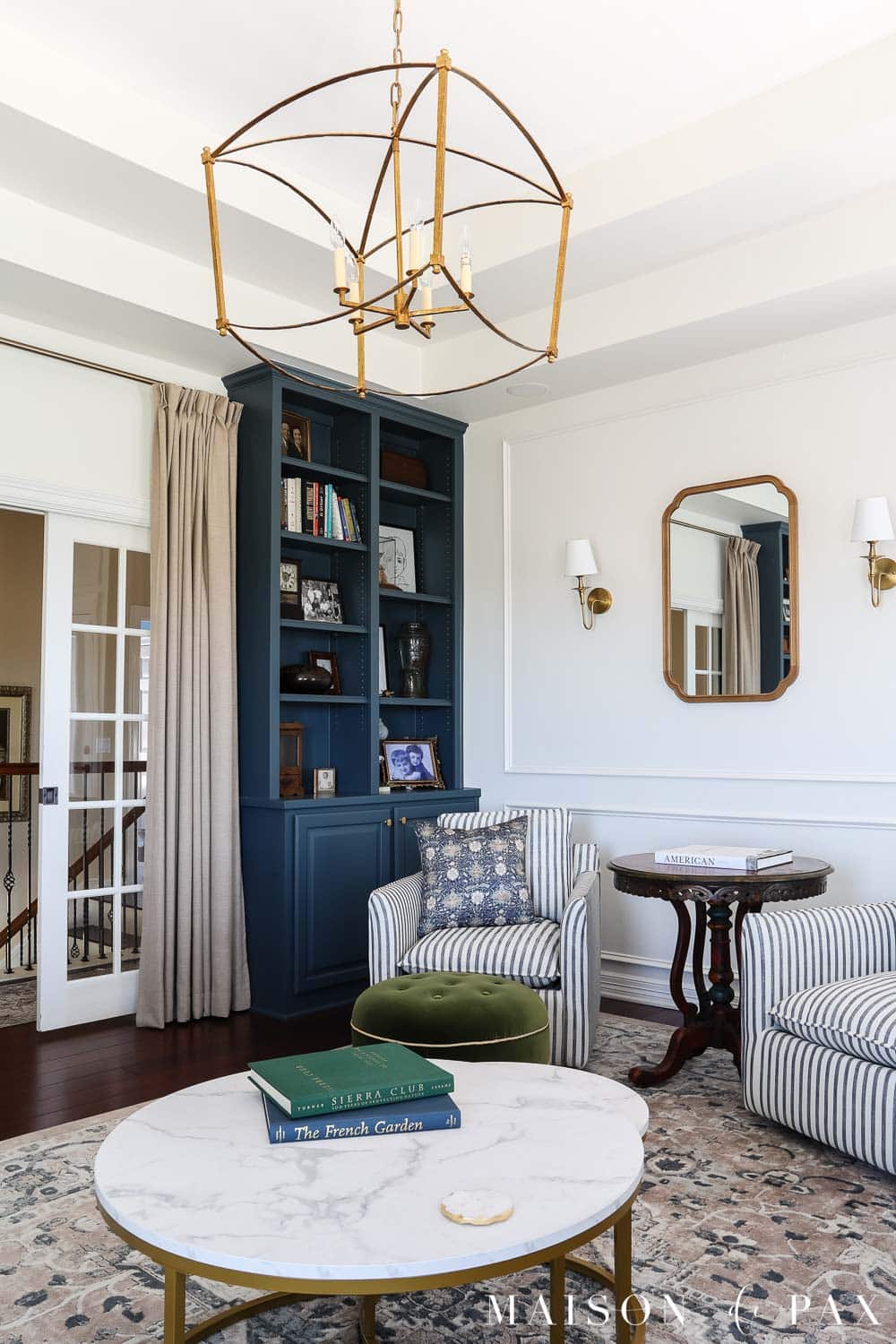 Elegant living room with dark blue bookcases painted sherwin williams rain cloud