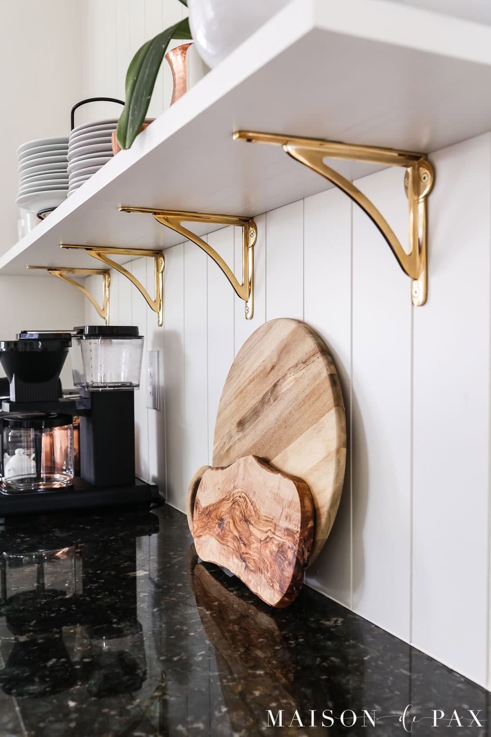 unlacquered brass brackets for open shelving in kitchen