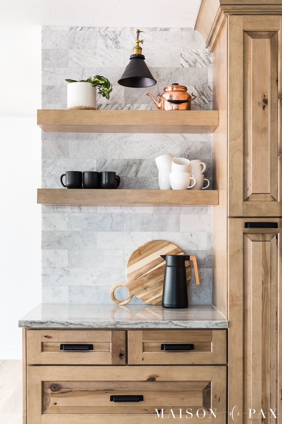 coffee bar with open shelves and marble backsplash