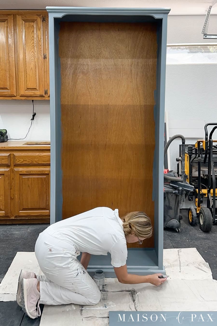 painting laminate bookcase with paint brush