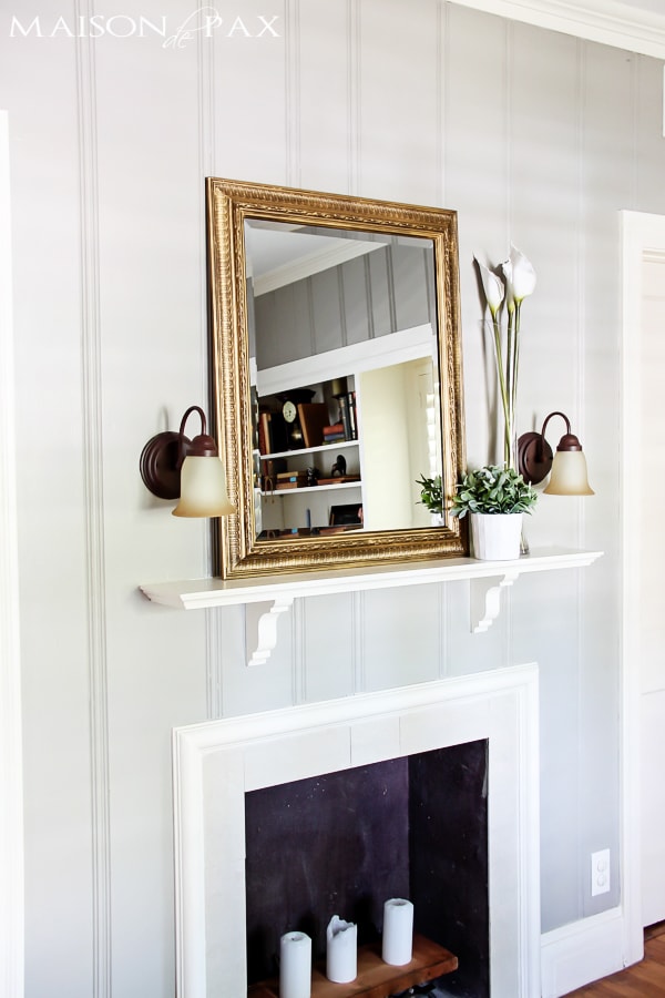 charming ornate gold mirror above small 1940's fireplace