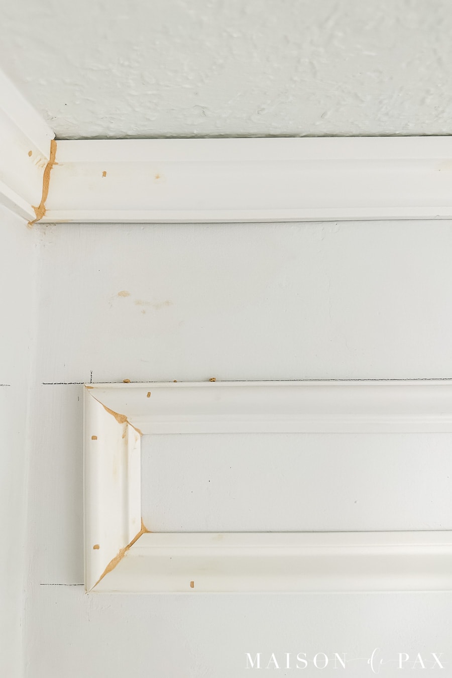using wood filler to hide imperfections in DIY picture frame molding