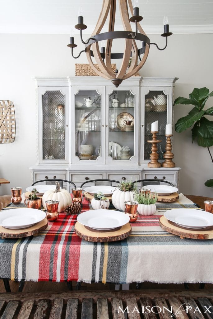 Be inspired to create a gorgeous, rustic Thanksgiving tablescape with these Thanksgiving decorating ideas! This table incorporates plaid, copper, and wood to create a beautiful yet relaxed look.
