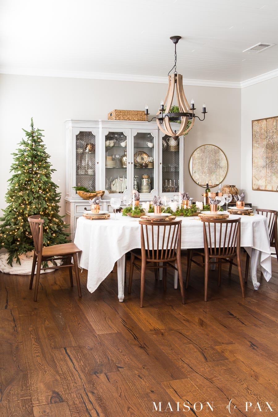 french country dining room with medium wood floors and a simple holiday tree