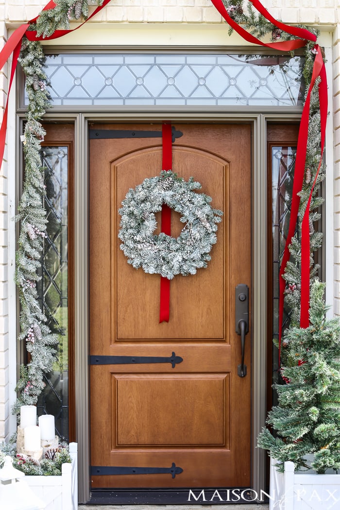 Greenery and Red Holiday Front Porch: What a beautiful, classic look! Get Christmas front porch decorating ideas here!