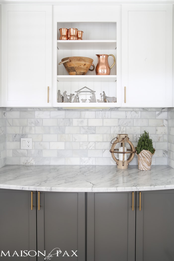 Gorgeous two-tone kitchen design with white upper cabinets, gray lower cabinets, carrara marble counters and marble subway tile backsplash- Maison de Pax