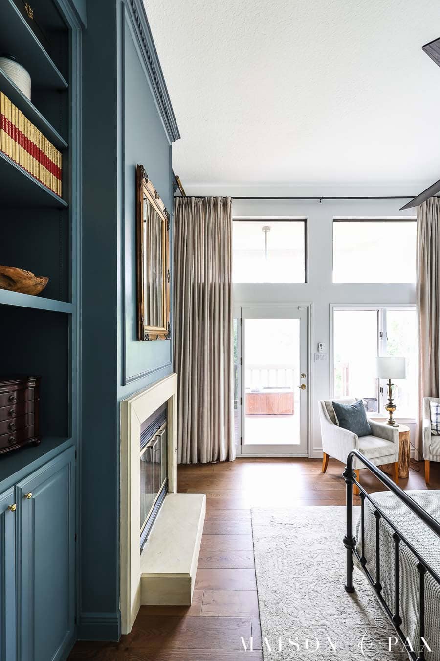 dark blue bookcases and fireplace in primary suite