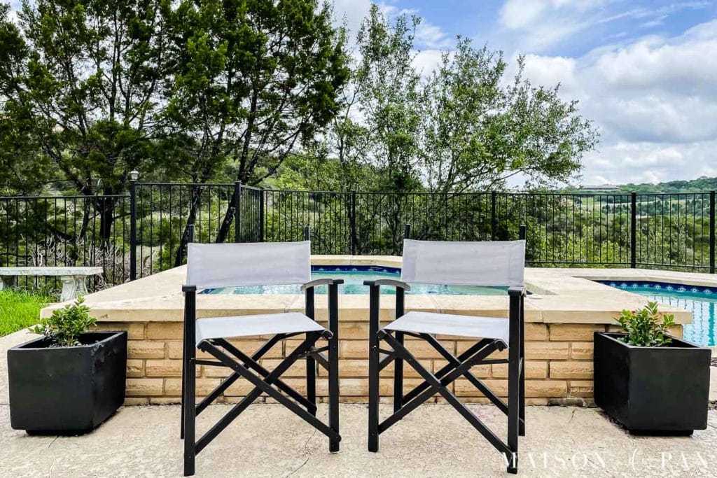 black and gray outdoor director's chairs by pool | Maison de Pax