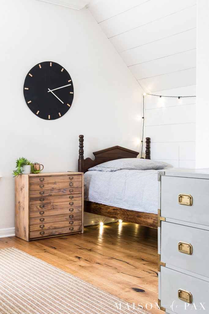 simple white room with plank wall and antique twin bed giving a modern look to a home build in the 90s | Maison de Pax