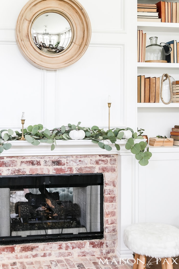 white pumpkins, brass candlesticks, and eucalyptus make a gorgeous fall mantel #fallmantel
