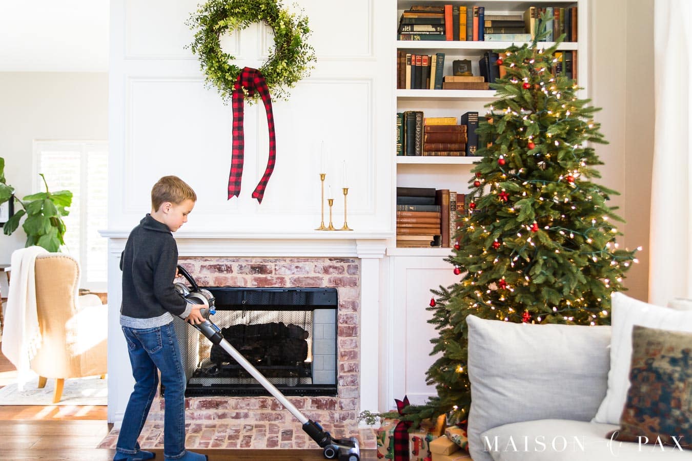 boy using Hoover ONEPWR Blade to vacuum needles under Christmas tree | Maison de Pax