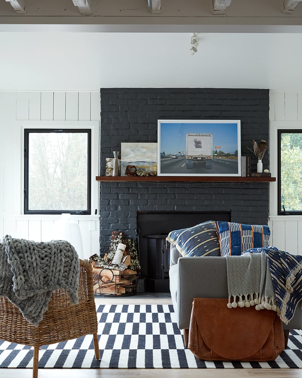 Allison Bloom - dark painted brick fireplace surround idea