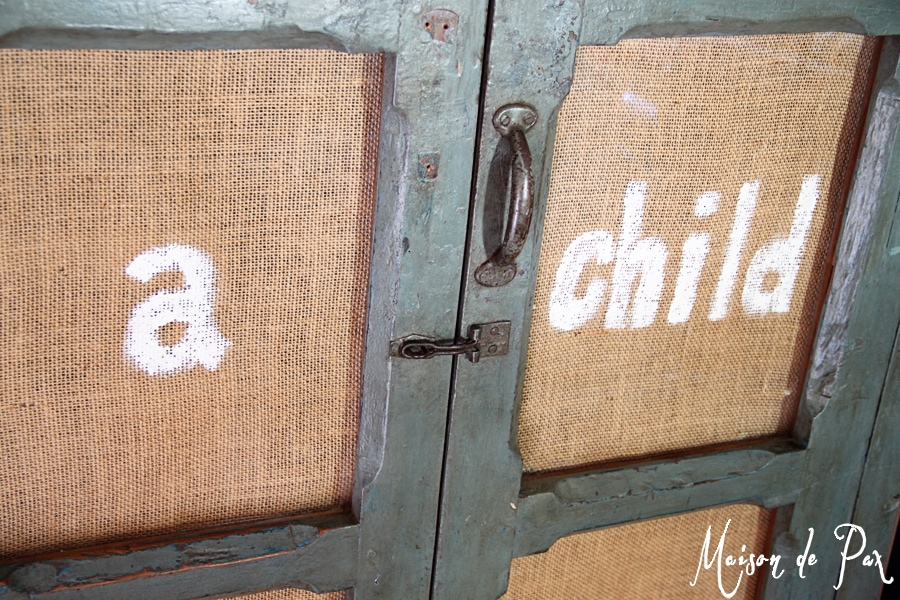 painted burlap inserted into glass doors adds texture and interest