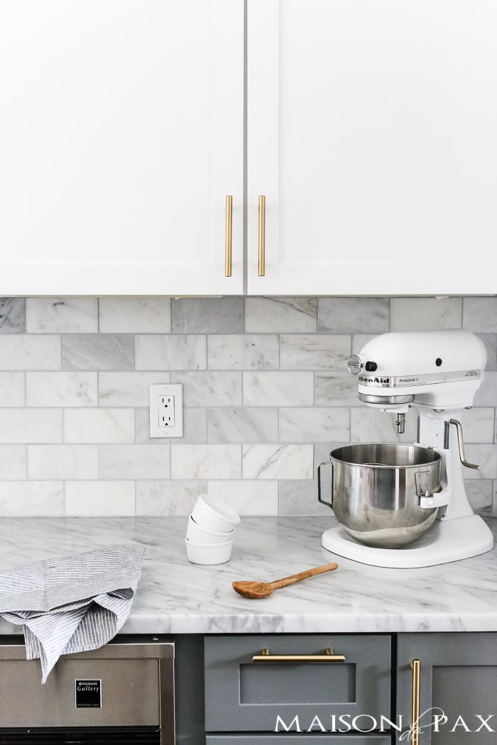 marble subway tile backsplash, white cabinets, gray lower cabinets- Maison de Pax