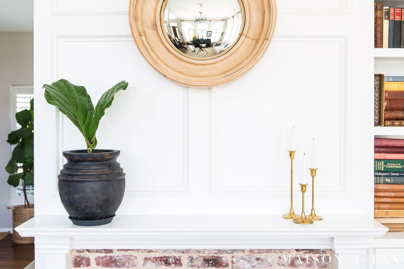 aged black pot and brass candlesticks on mantel | Maison de Pax