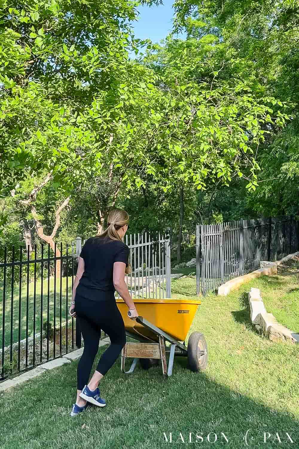 woman using wheelbarrow to do yard work
