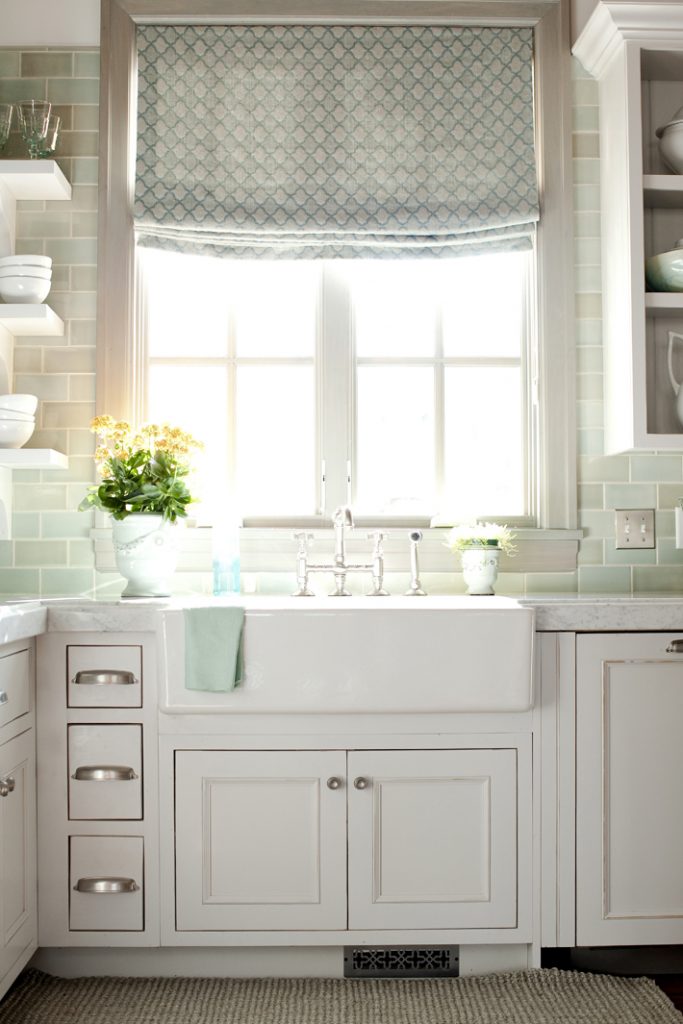 white kitchen with green glass subway backsplash