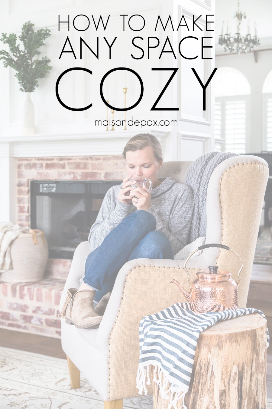 woman drinking tea in armchair by fireplace | Maison de Pax