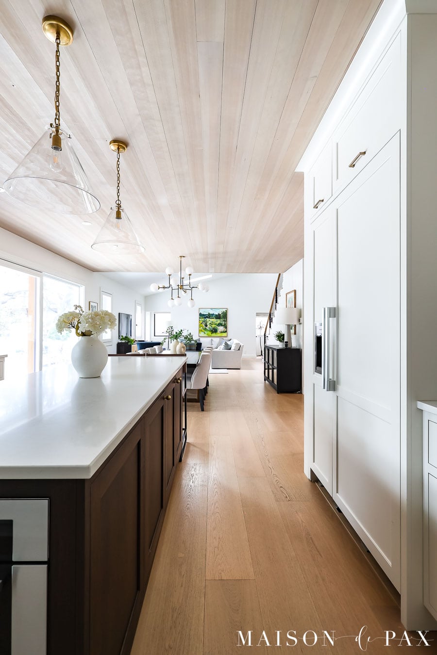 hemlock wood ceilings and white oak floors in kitchen with walnut island and white cabinetry