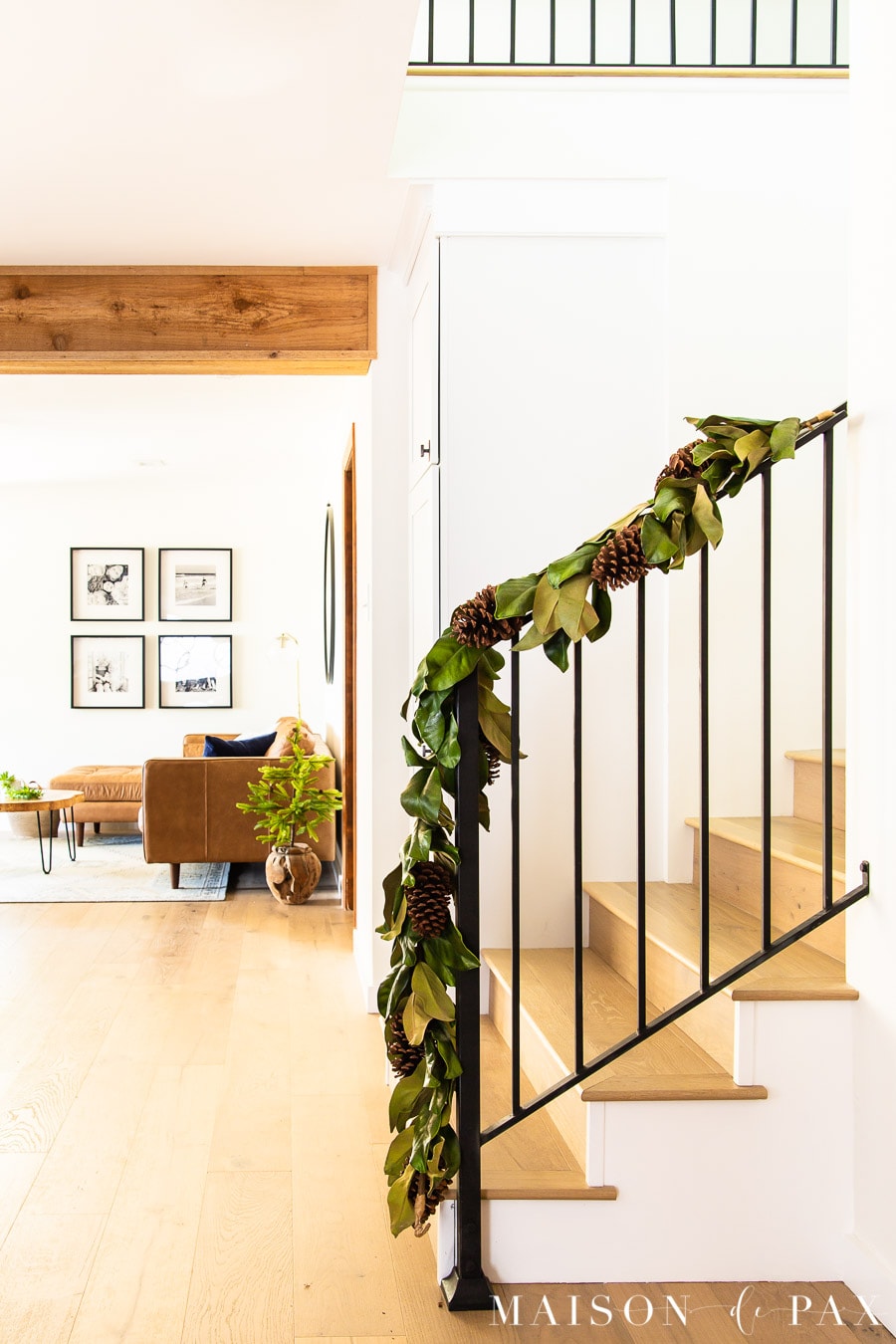 black metal banister with magnolia leaf garland | Maison de Pax