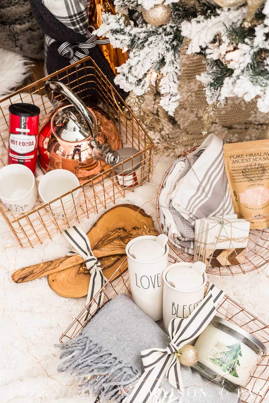 copper baskets filled with home gifts under a christmas tree