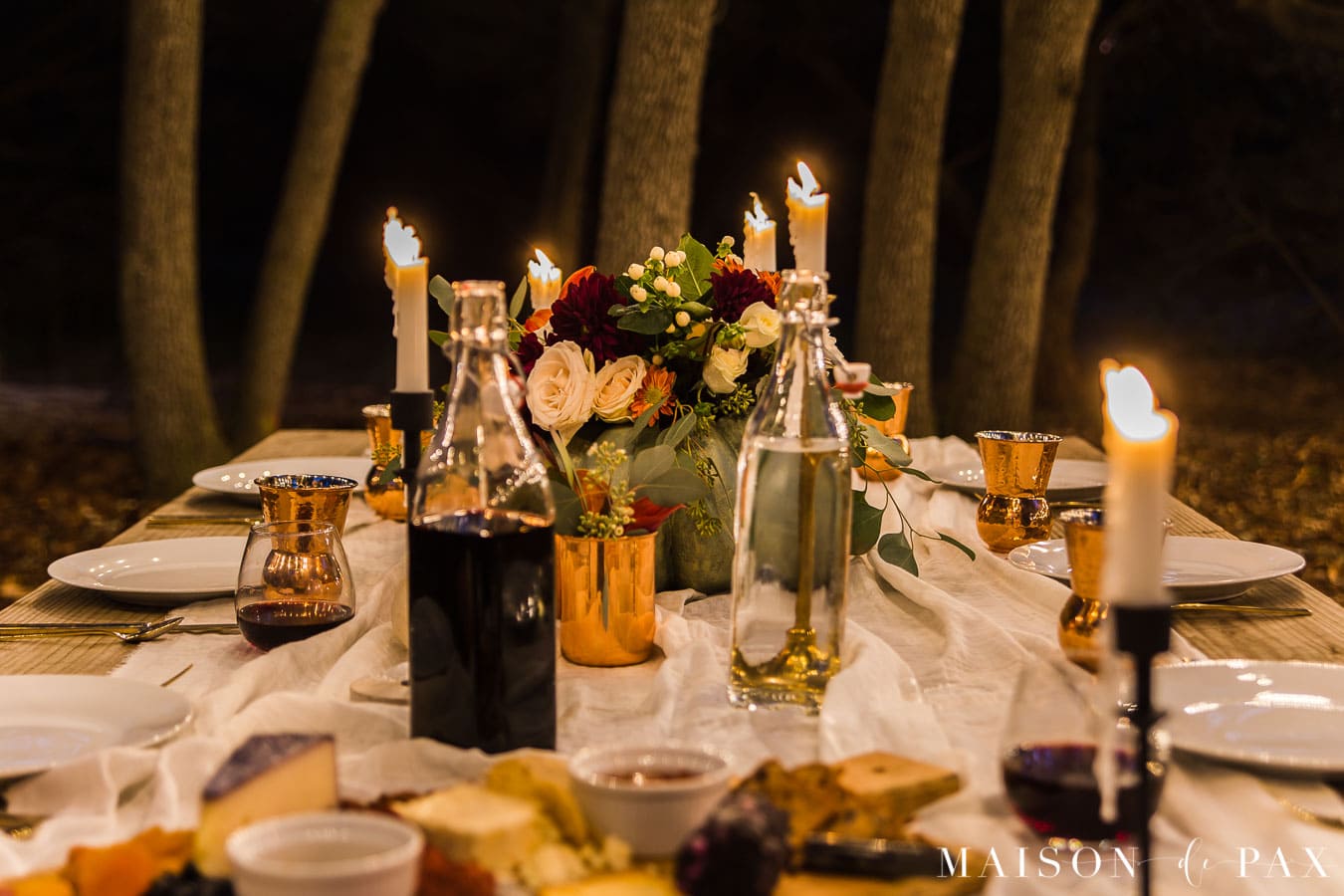 nighttime outdoor Thanksgiving table with taper candles | Maison de Pax