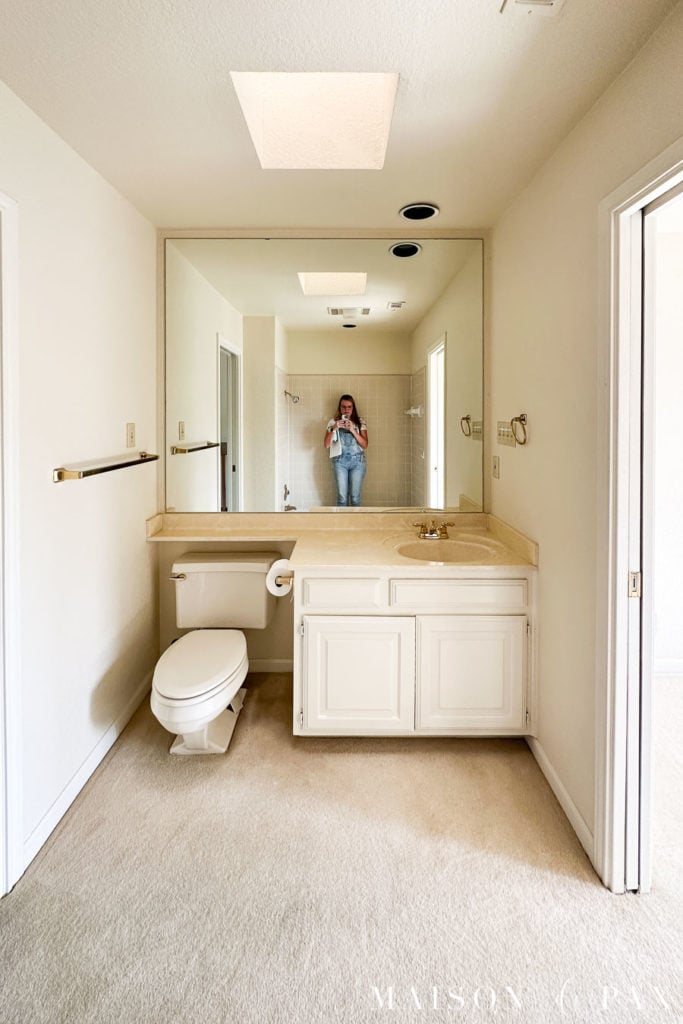 small 80s bath with carpet and single sink before renovation