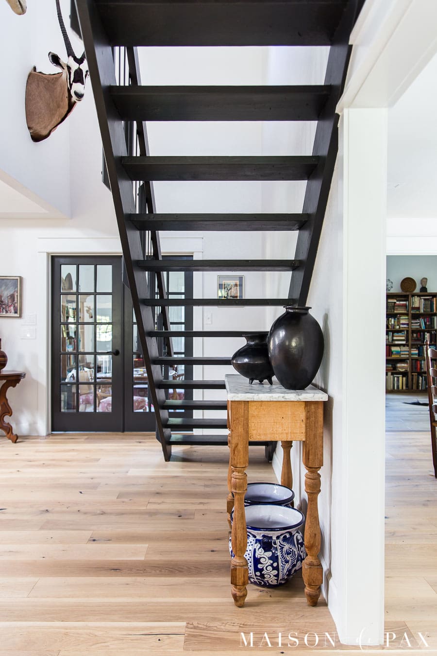 see through black floating staircase in eclectic home