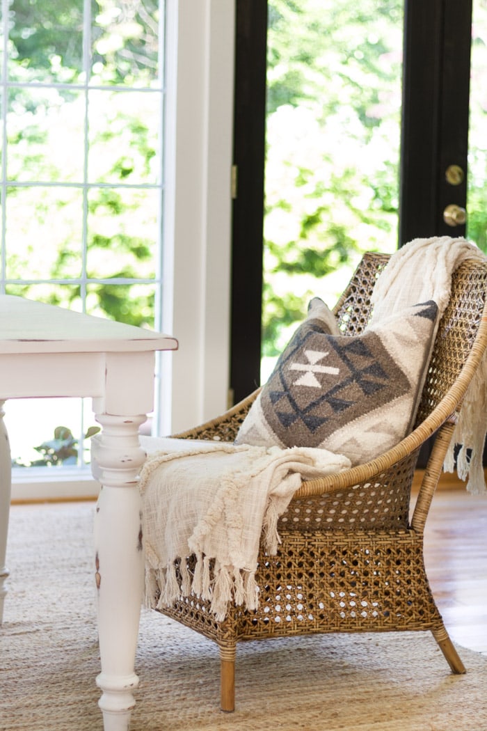 Wicker dining room chair with throw blanket- Maison de Pax