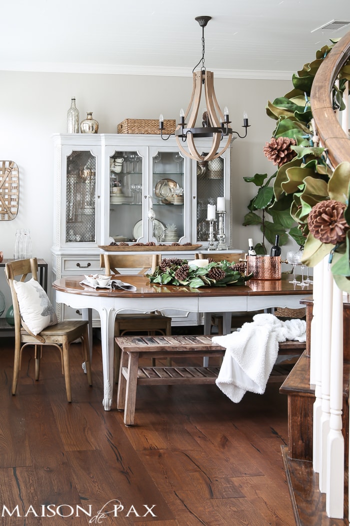 simple greenery and mercury glass makes this French farmhouse style dining room all set for Christmas!