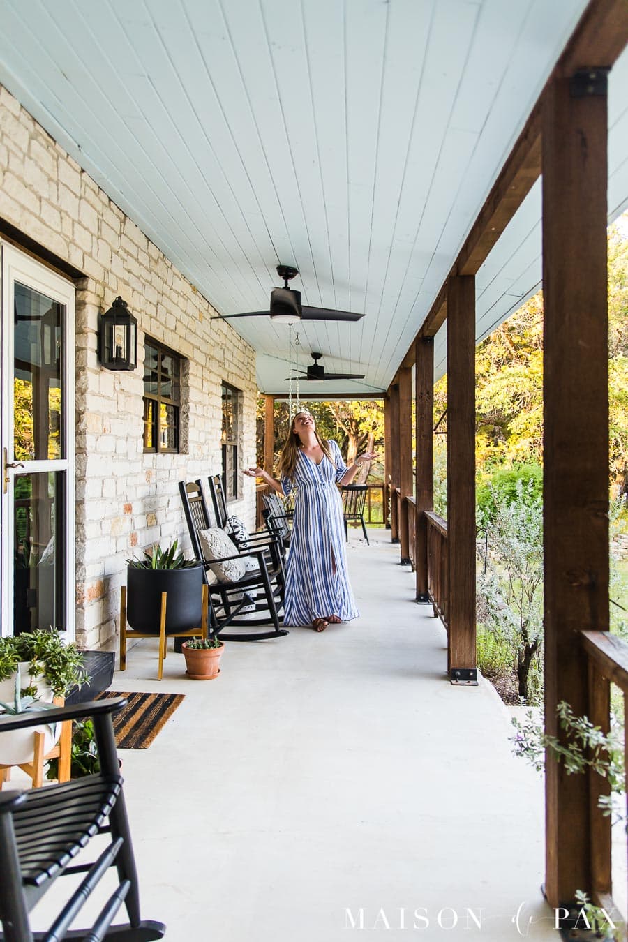 woman enjoying outdoor fans on front porch | Maison de Pax