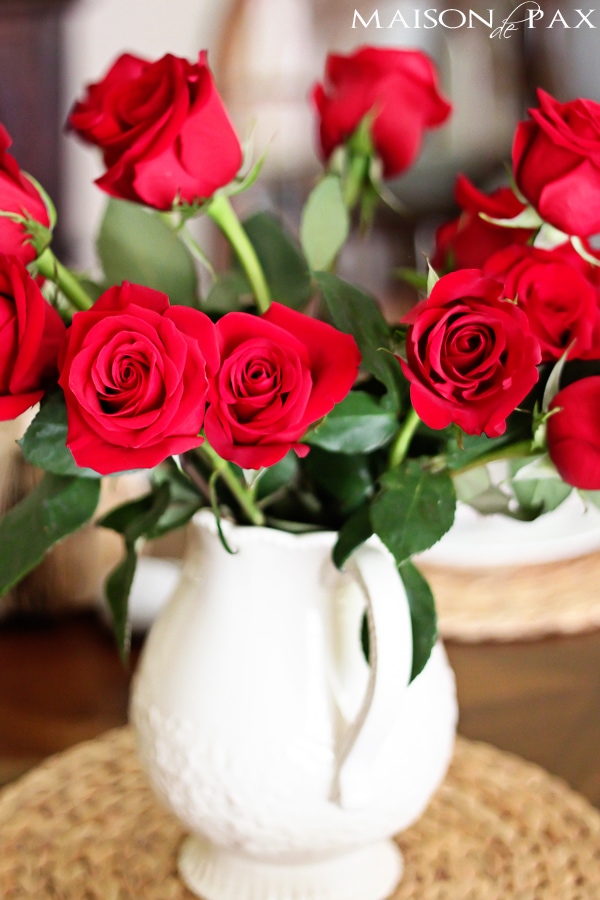 A vase of red roses- Maison de Pax