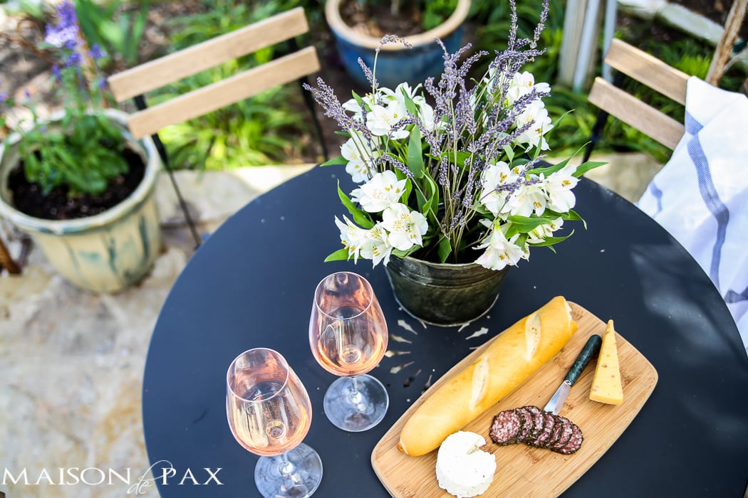 al fresco bistro dining with rose, french bread, and cheese | Maison de Pax