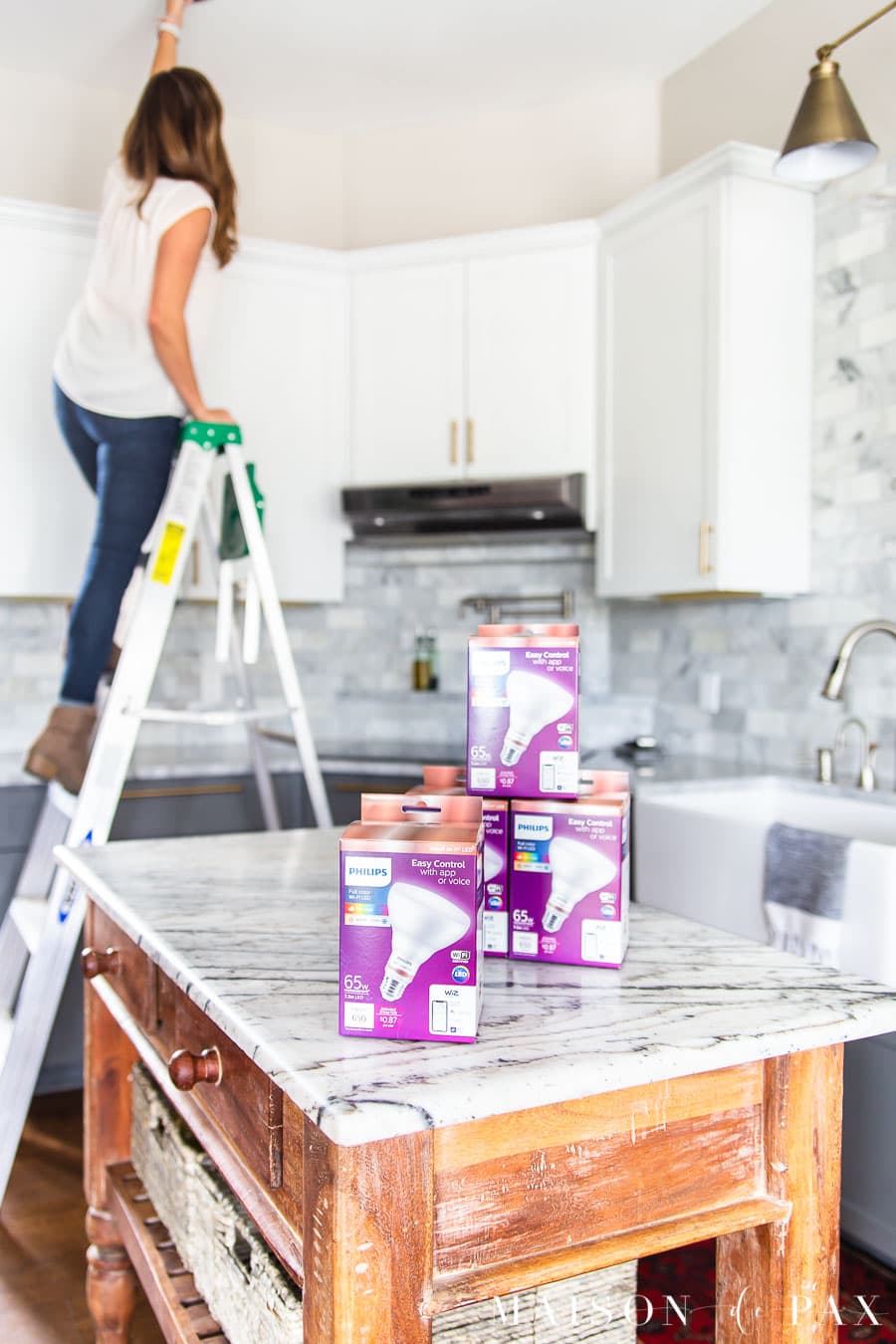 woman installing smart bulbs | Maison de Pax