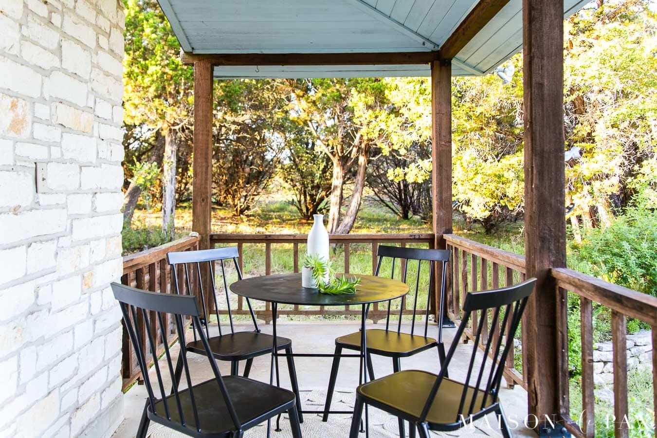 black metal bistro set with four chairs on outdoor patio | Maison de Pax
