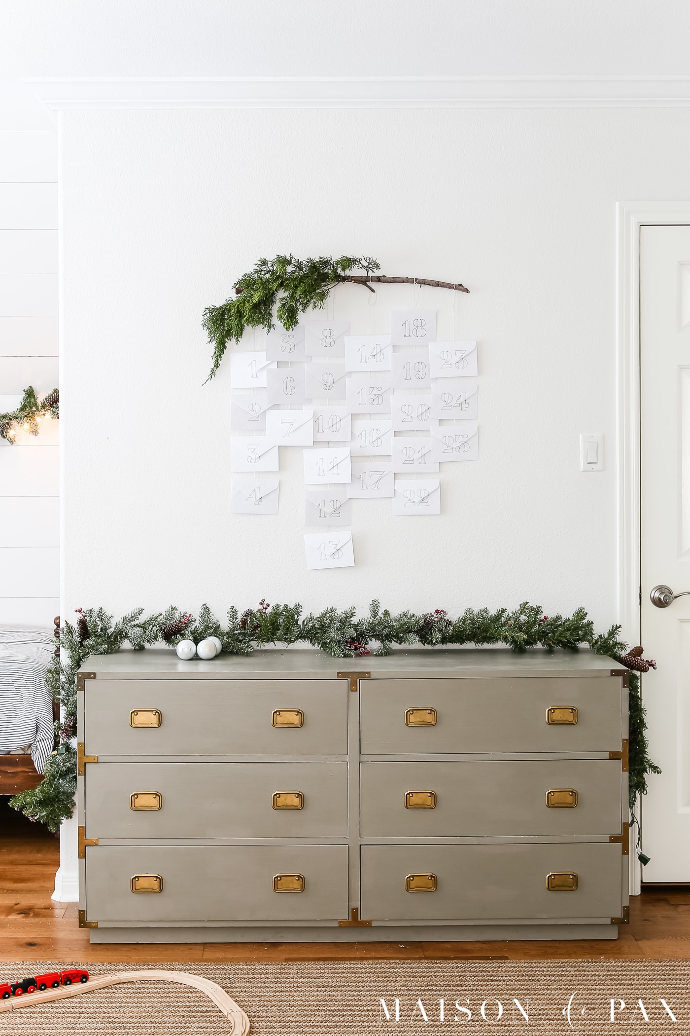 evergreen branch and simple white envelopes make an adorable diy advent calendar #adventcalendar