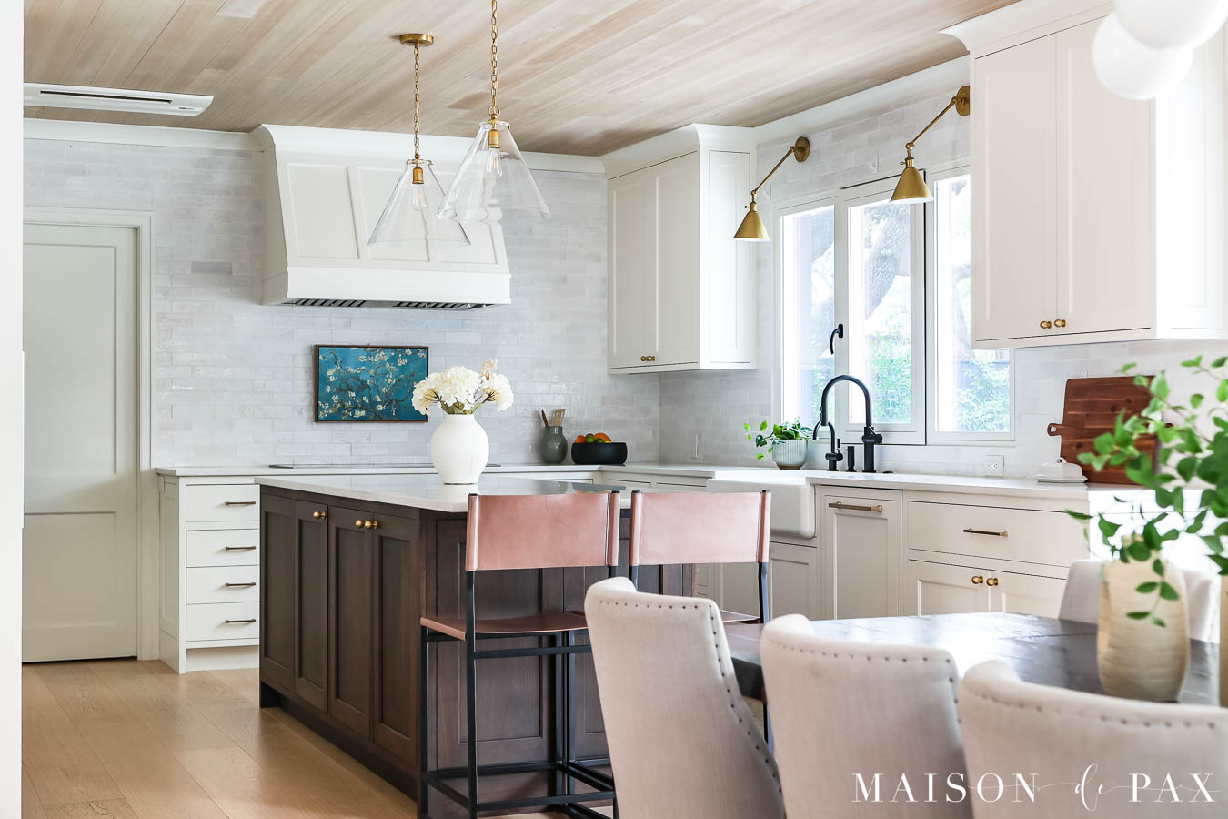 dining table near kitchen with two barstools