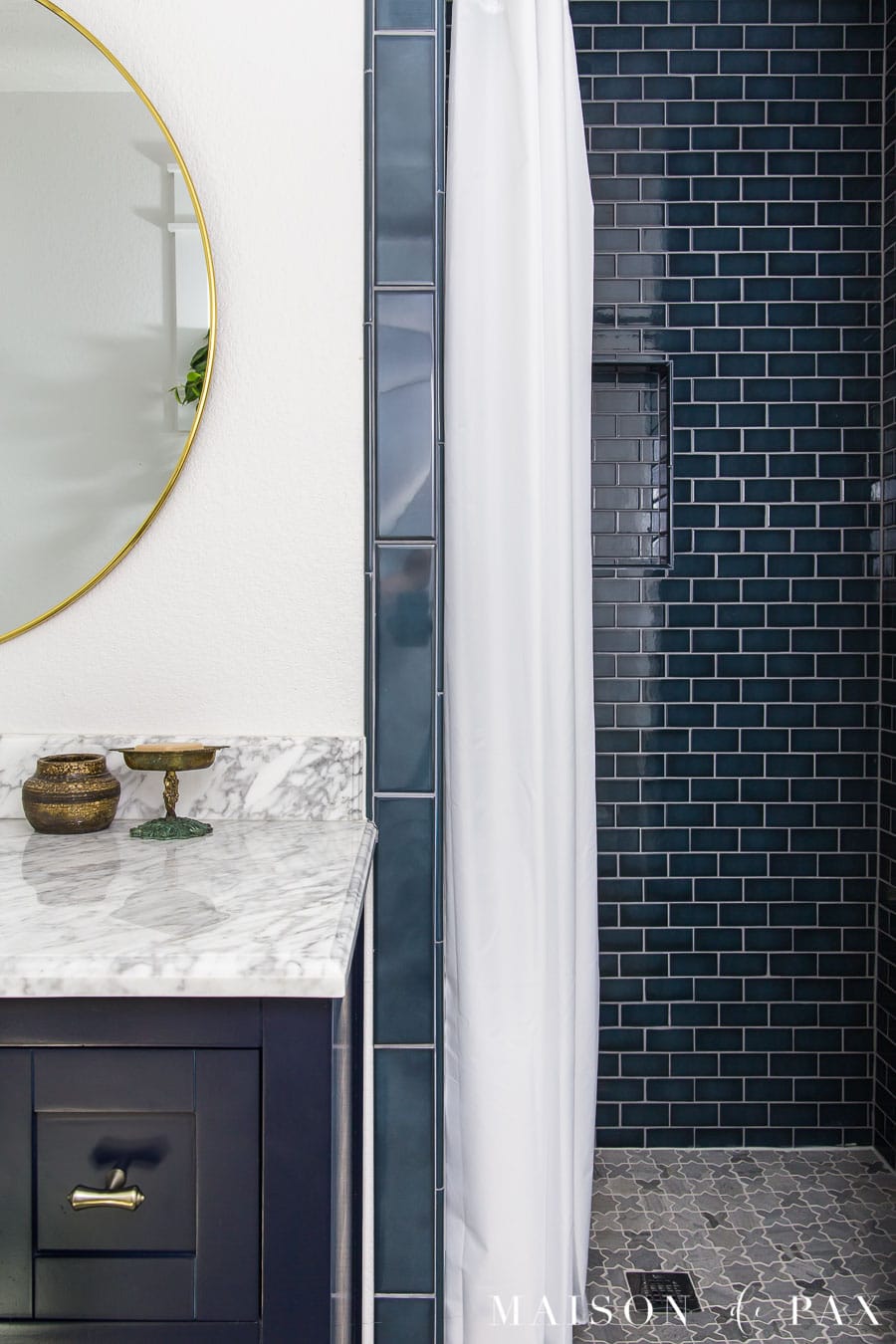 dark blue shower tile and marble floors
