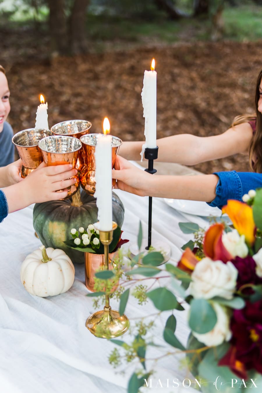 cheers with copper cups at Thanksgiving table | Maison de Pax