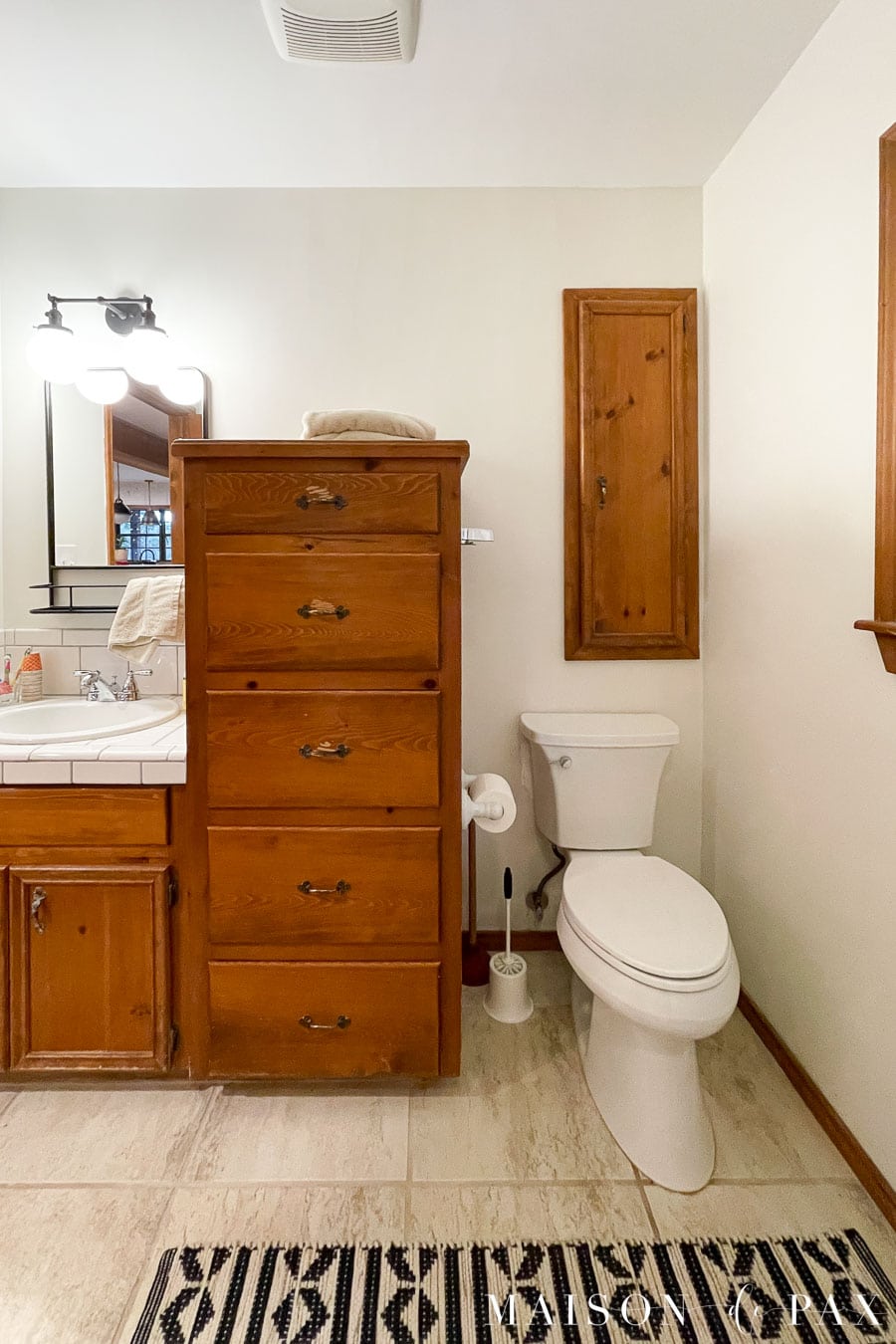 bathroom with wood cabinets before makeover