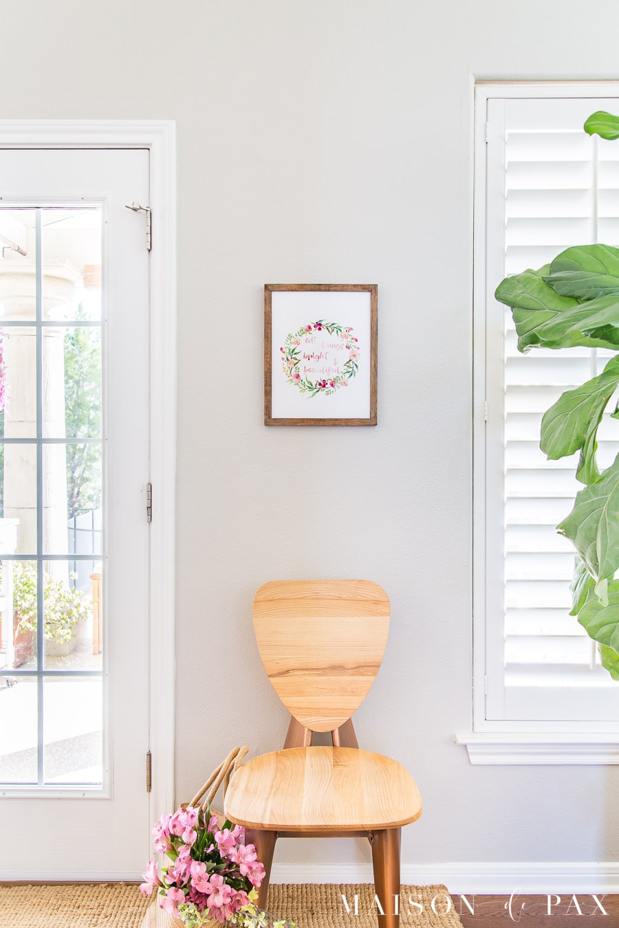 light wood chair with watercolor wall art above | Maison de Pax