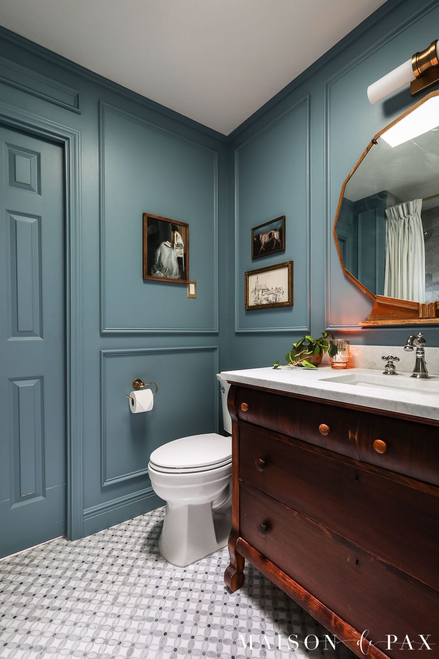 blue bathroom with mosaic marble floor tiles that look like little flowers
