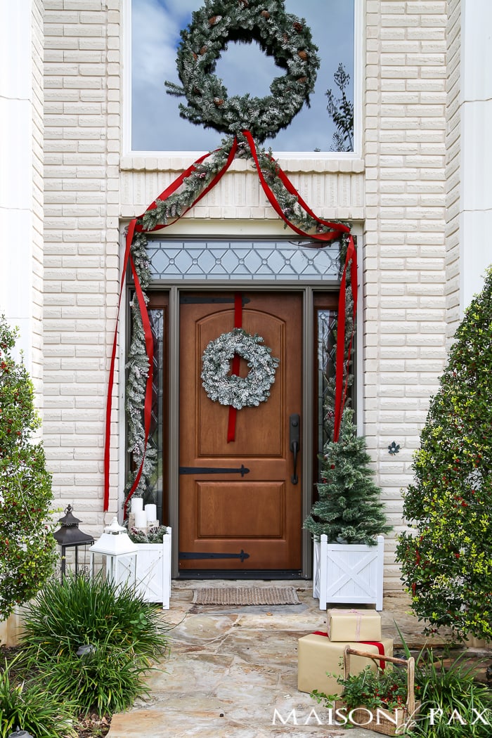 Greenery and Red Holiday Front Porch: What a beautiful, classic look! Get Christmas front porch decorating ideas here!