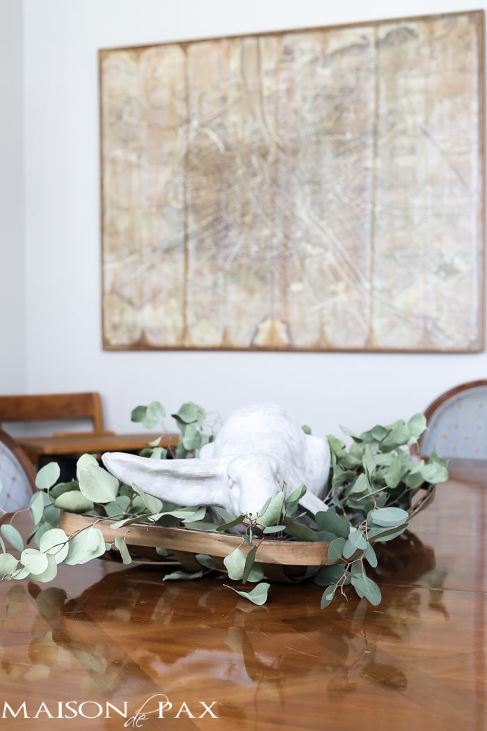 What a cute, simple idea for Easter decor! Use a garden statue bunny in a basket with dried greens as a centerpiece for your table | aiweb9ygdry.cmersite.com