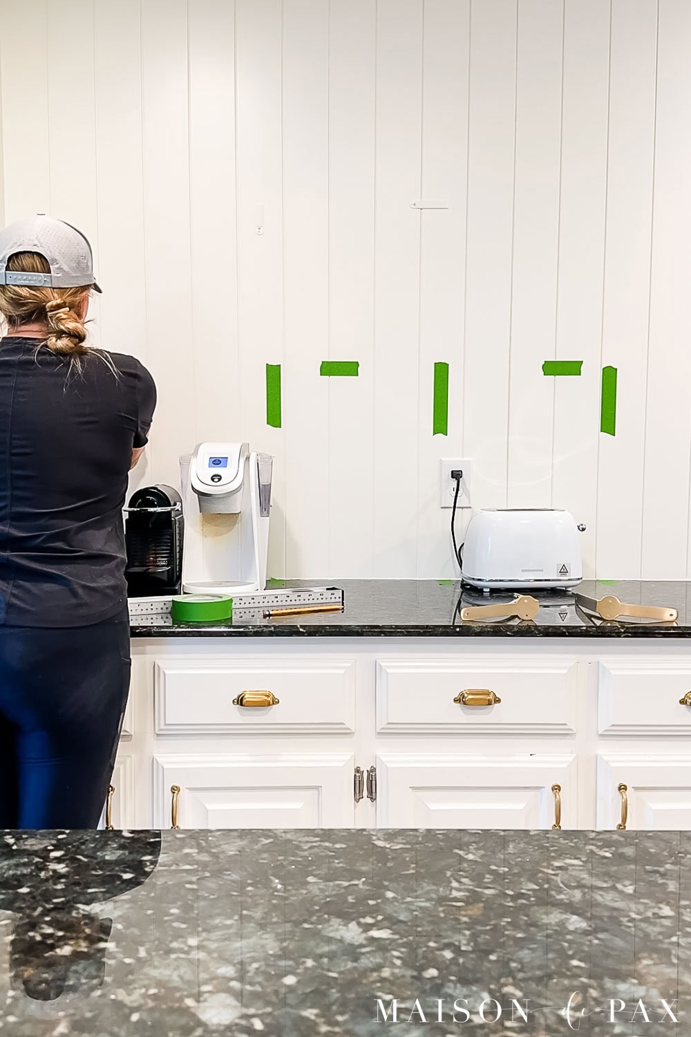 use painters tape to mark out floating shelves or open shelves and bracket placement before drilling into the wall