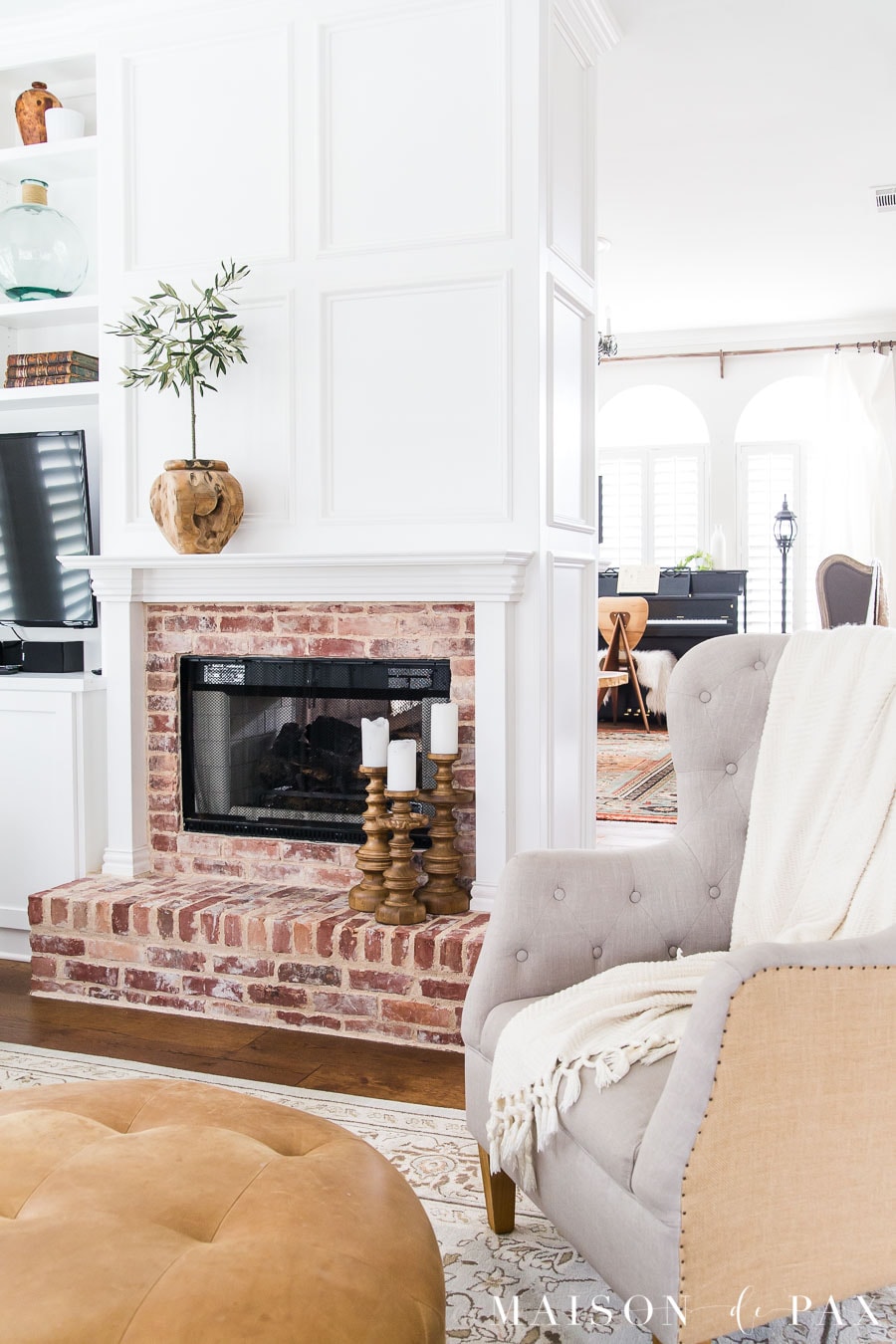 fireplace with white molding and antique brick in a beauitfully updated 1990s home | Maison de Pax