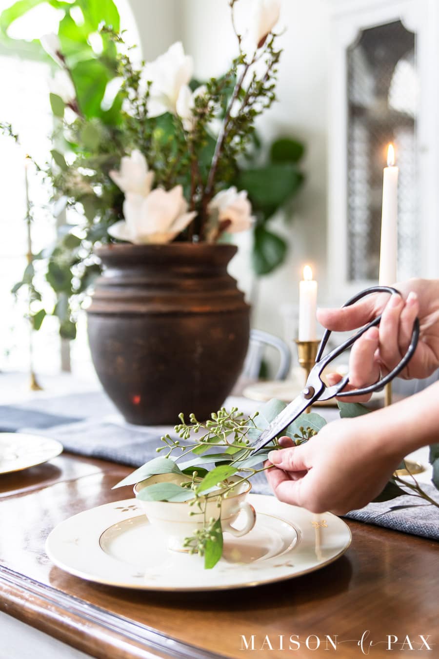 cutting eucalyptus clippings for teacups on plates | Maison de Pax