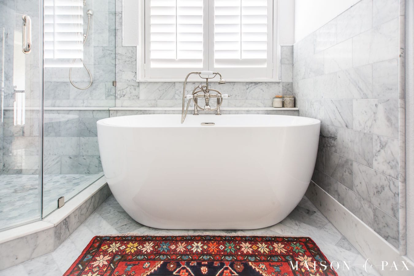 colorful vintage persian rug in front of freestanding tub | Maison de Pax