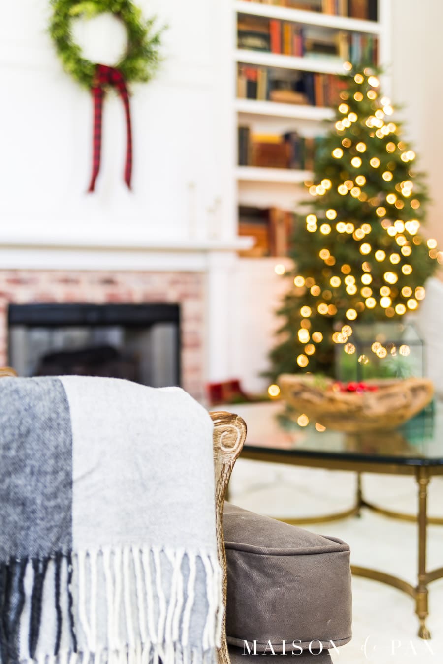 black and white wool plaid throw over arm of gray chair in christmas living room | Maison de Pax