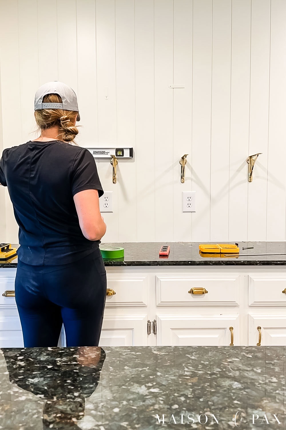 use level to install shelf brackets for open shelving